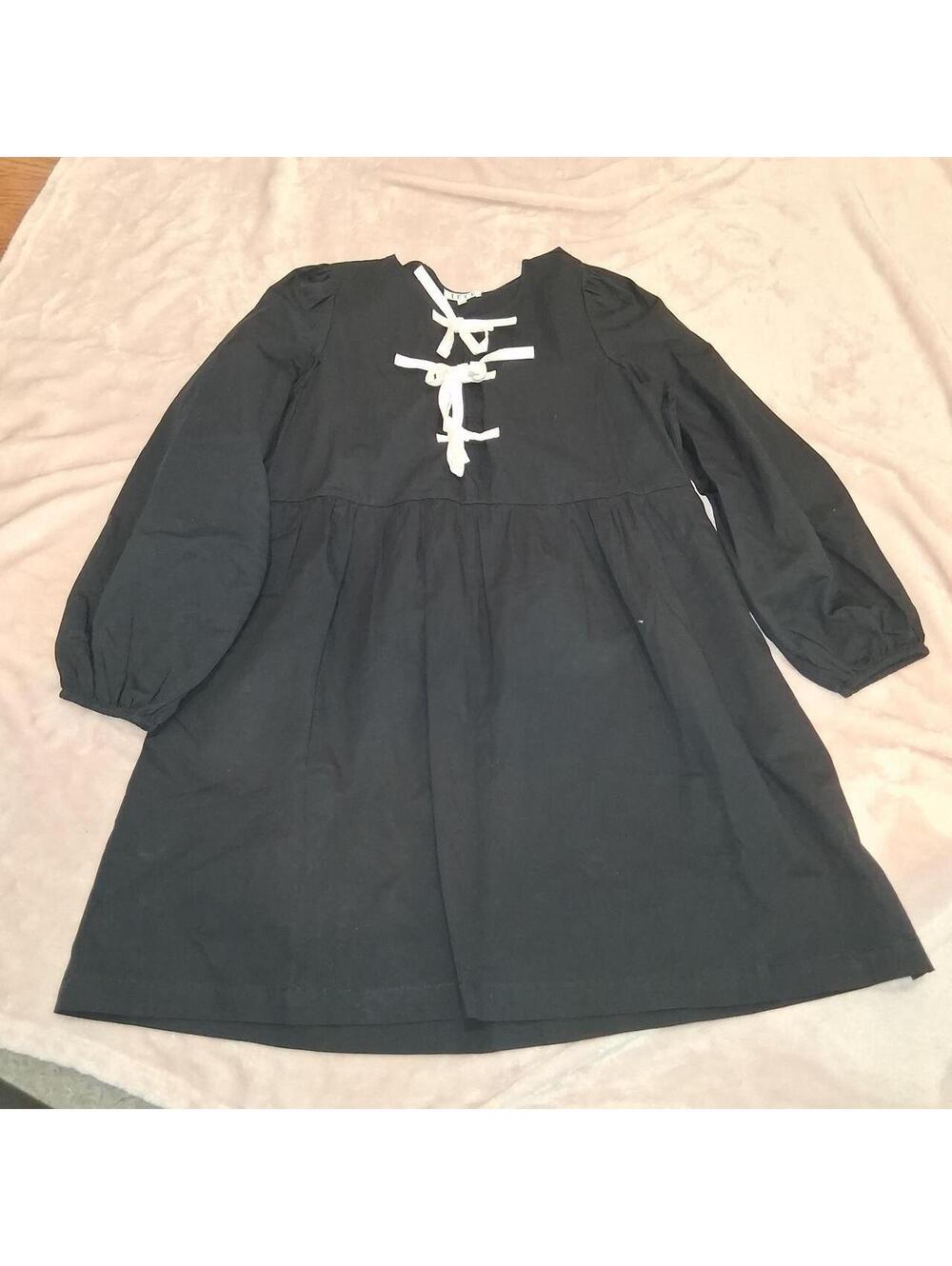 Black dress with white bow design, size M